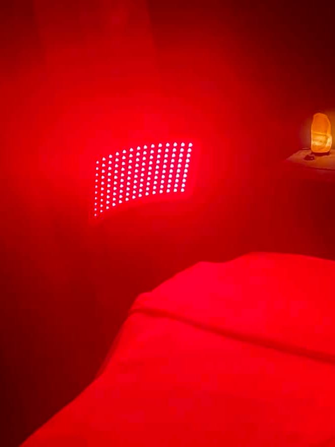 Close-up of the curved LED panel glowing beside a salt lamp